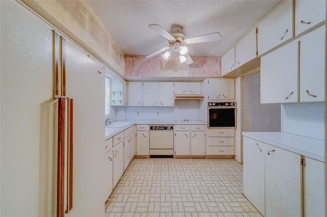 kitchen featuring white cabinetry, white appliances, and a textured ceiling