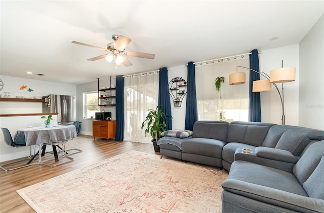 living room with ceiling fan and wood-type flooring