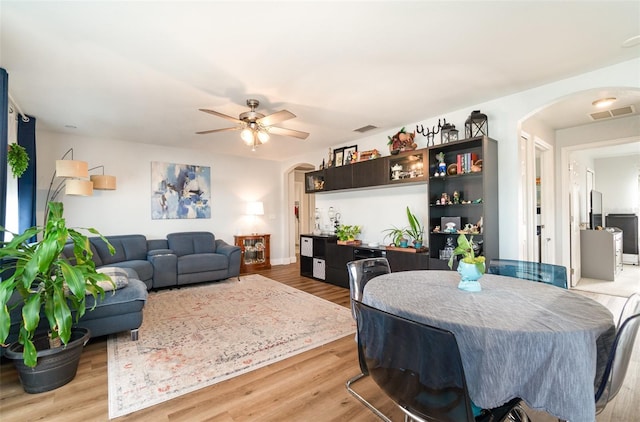 dining room with ceiling fan and light hardwood / wood-style floors