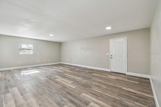 spare room featuring wood-type flooring