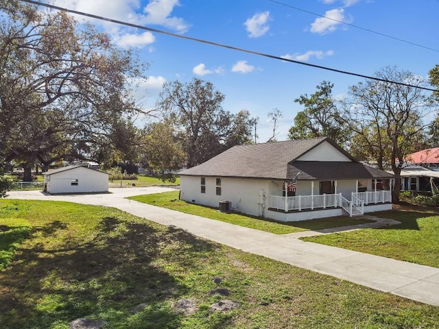 view of home's exterior with covered porch, central AC, and a lawn