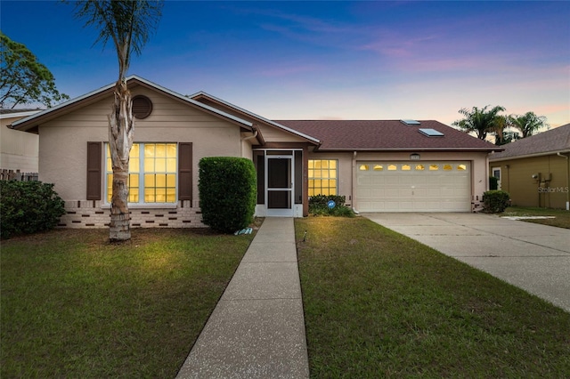 ranch-style house with a yard and a garage