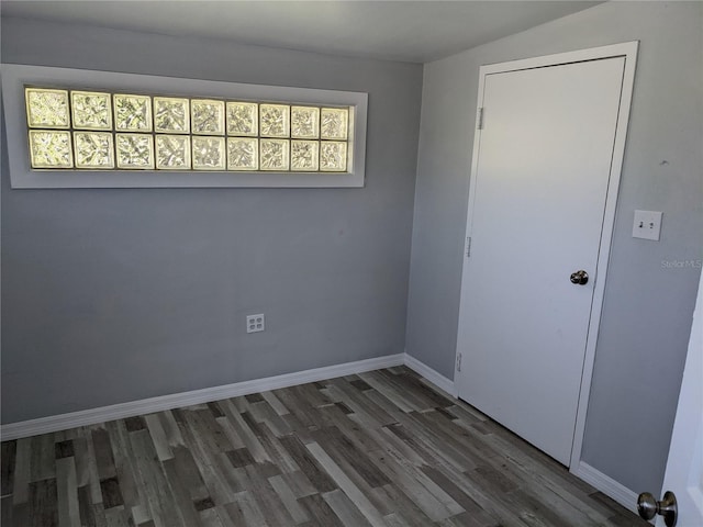 empty room featuring dark hardwood / wood-style flooring