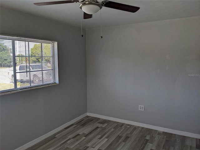 spare room with ceiling fan and dark hardwood / wood-style floors