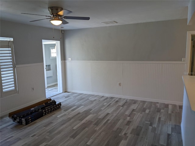 unfurnished living room with ceiling fan and hardwood / wood-style flooring