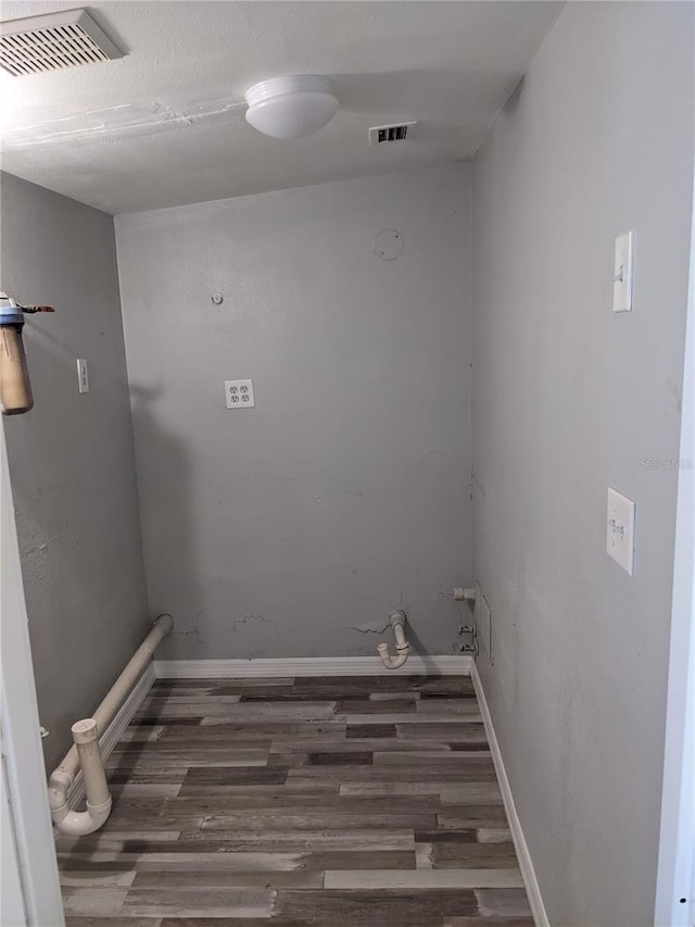 clothes washing area featuring dark hardwood / wood-style floors