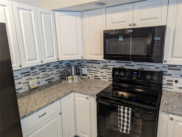 kitchen with black appliances, decorative backsplash, light stone countertops, and white cabinetry