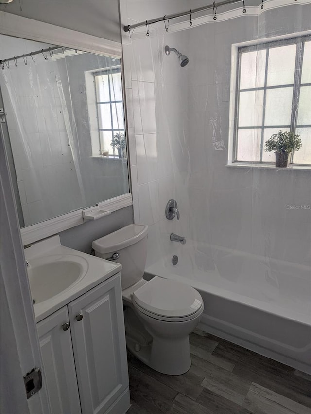 full bathroom featuring shower / bath combination with curtain, toilet, and vanity