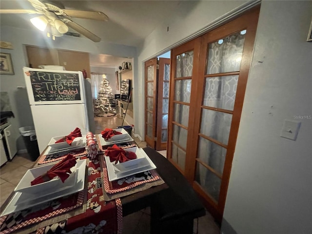 dining area featuring ceiling fan, french doors, and light tile patterned floors