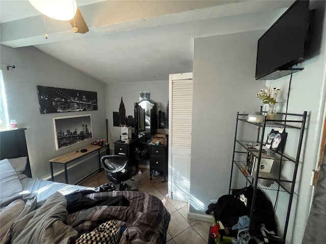 tiled living room featuring ceiling fan and vaulted ceiling