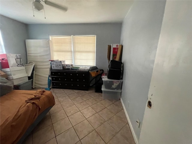 tiled bedroom featuring ceiling fan