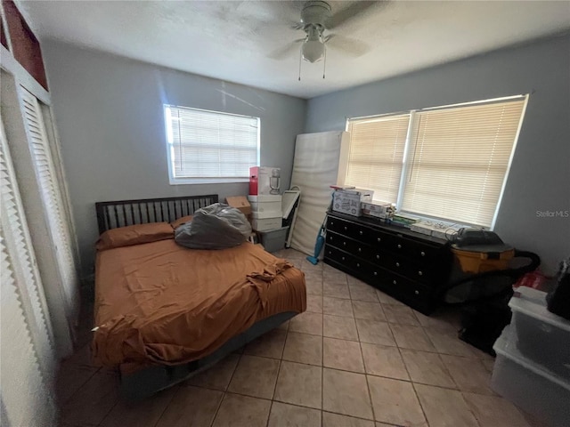 bedroom with light tile patterned floors and ceiling fan