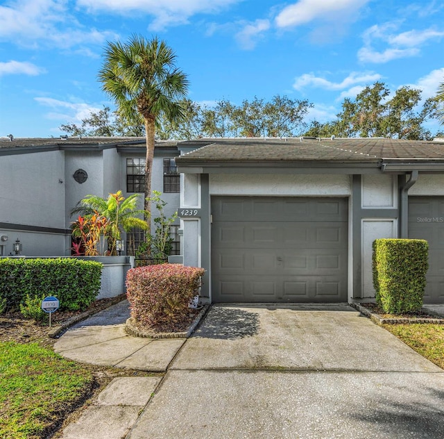 view of front of home with driveway, a garage, and stucco siding