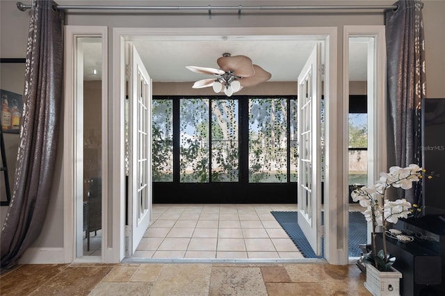 sunroom featuring ceiling fan and french doors