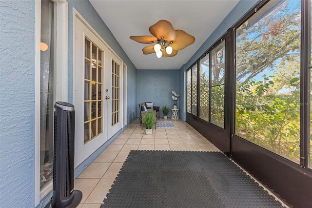 unfurnished sunroom featuring french doors and ceiling fan