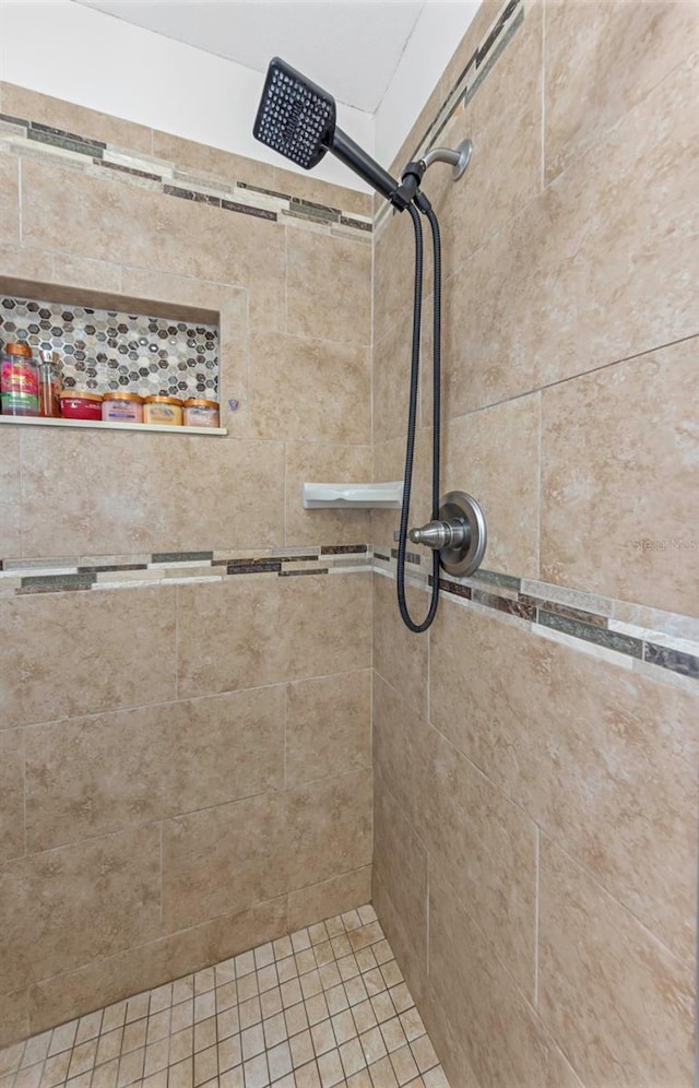 bathroom with a tile shower