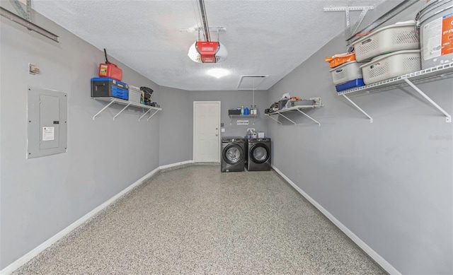 walk in closet featuring washing machine and clothes dryer, electric panel, and attic access