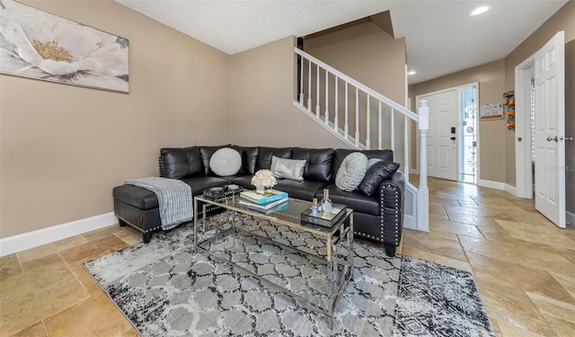 living area featuring stairway, baseboards, stone tile flooring, and recessed lighting