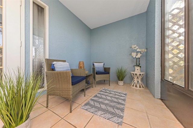 interior space with a textured wall and tile patterned flooring