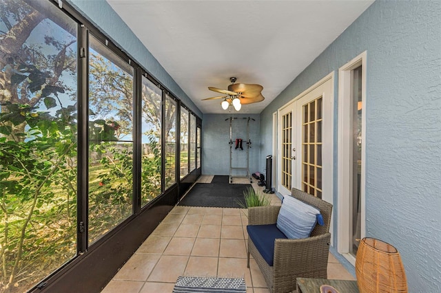 sunroom / solarium featuring ceiling fan