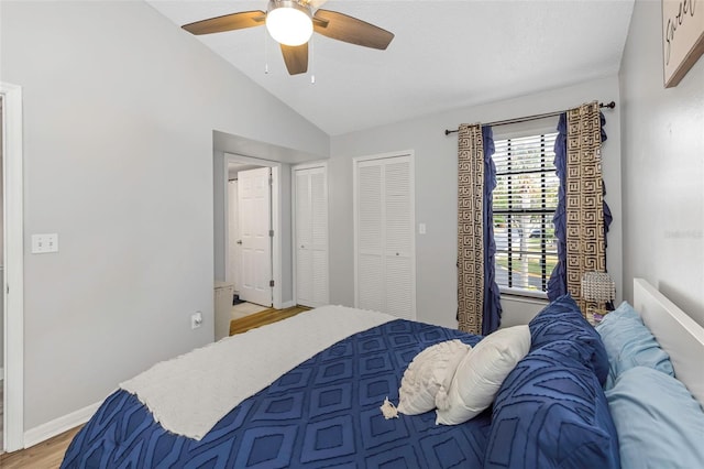 bedroom featuring vaulted ceiling, ceiling fan, light wood finished floors, and baseboards