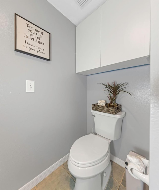 bathroom featuring visible vents, toilet, baseboards, and tile patterned floors