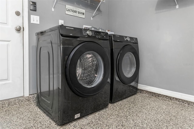 washroom featuring laundry area, independent washer and dryer, and baseboards