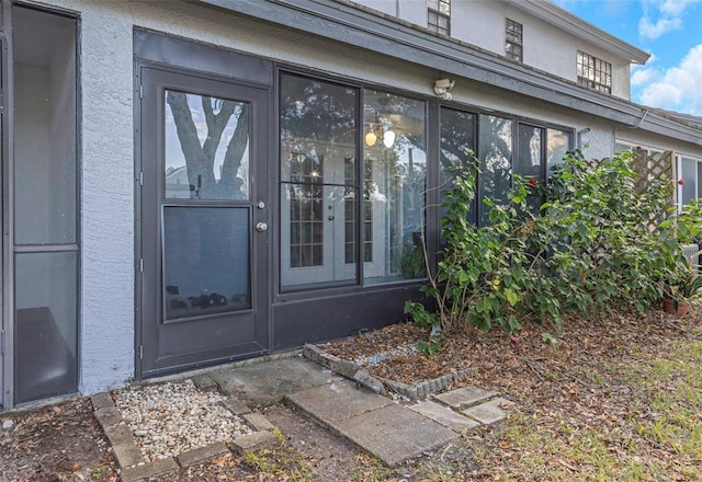 property entrance featuring stucco siding