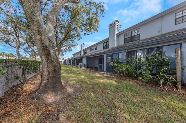 view of yard with a sunroom