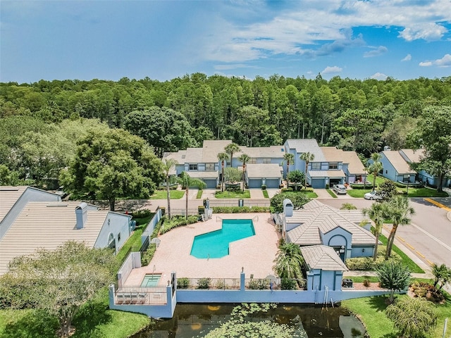 birds eye view of property featuring a view of trees