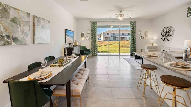 dining area with light tile patterned floors and ceiling fan