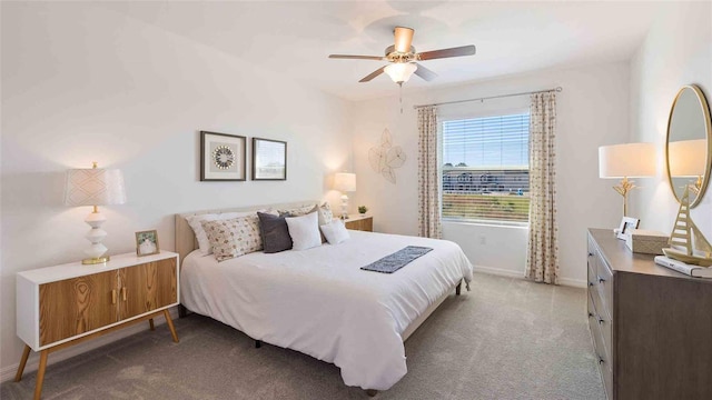 bedroom featuring ceiling fan and light colored carpet