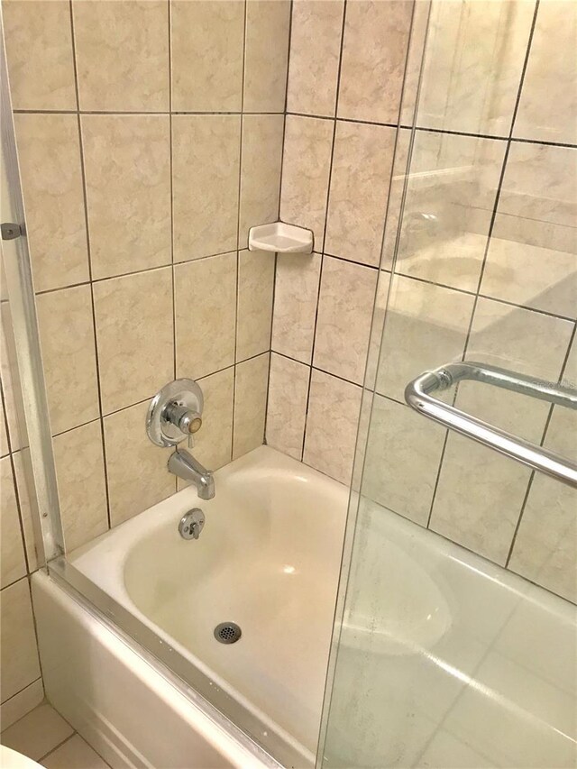 bathroom featuring tile patterned floors and tiled shower / bath