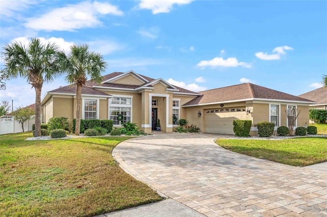 view of front of home featuring a front lawn and a garage