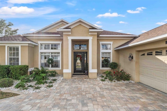 view of exterior entry with a garage