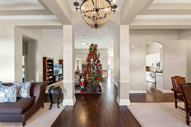 foyer featuring a chandelier, wood-type flooring, and crown molding