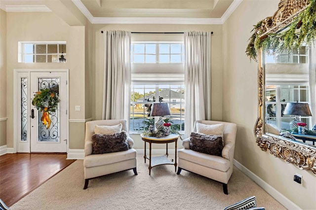 sitting room featuring wood-type flooring and ornamental molding