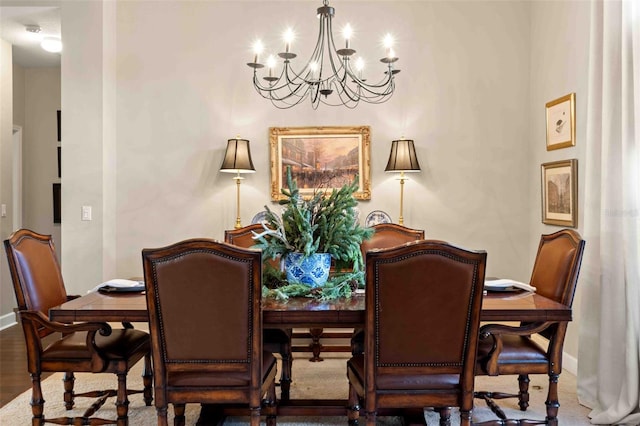 dining area with hardwood / wood-style flooring and a notable chandelier