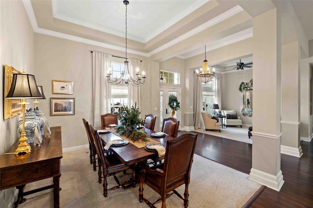 dining room featuring hardwood / wood-style flooring, ceiling fan, a raised ceiling, and ornamental molding