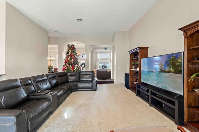 carpeted living room with ceiling fan