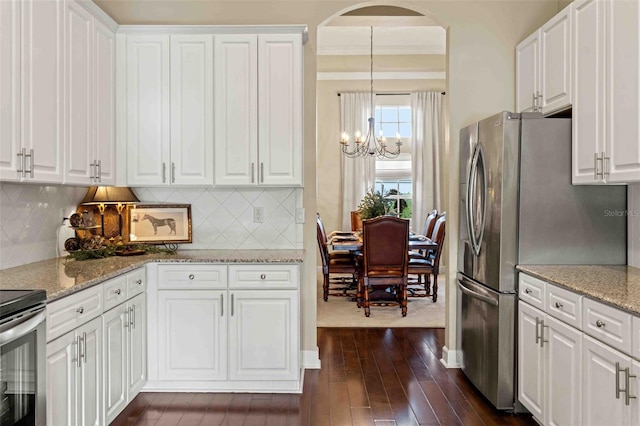 kitchen with white cabinetry and hanging light fixtures