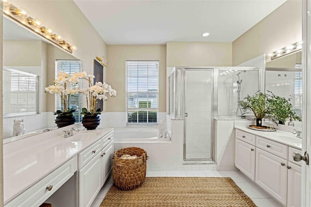 bathroom featuring tile patterned flooring, shower with separate bathtub, and vanity