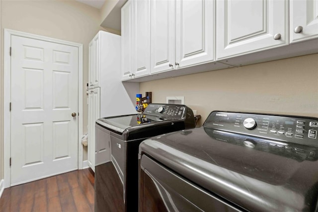 laundry area with cabinets, dark hardwood / wood-style flooring, and separate washer and dryer