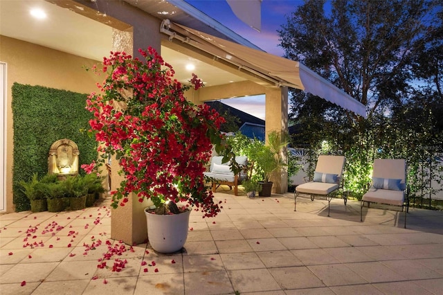 view of patio terrace at dusk