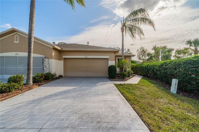 view of front of property featuring a garage and a front lawn