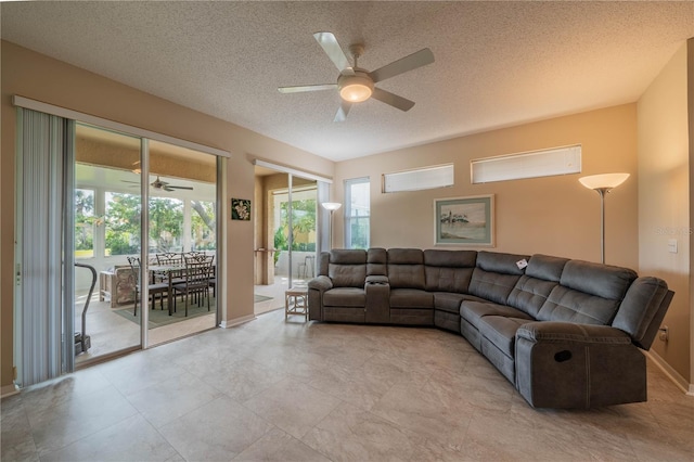 living room featuring a textured ceiling, plenty of natural light, and ceiling fan