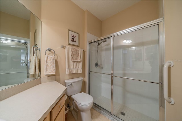 bathroom with vanity, toilet, a shower with shower door, and a textured ceiling