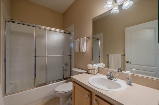 full bathroom with vanity, toilet, and enclosed tub / shower combo