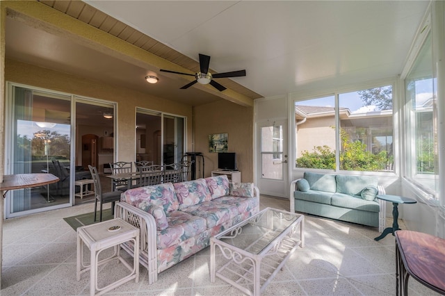 sunroom / solarium featuring ceiling fan