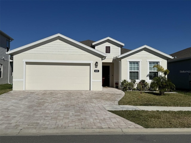 view of front of property featuring a garage and a front yard